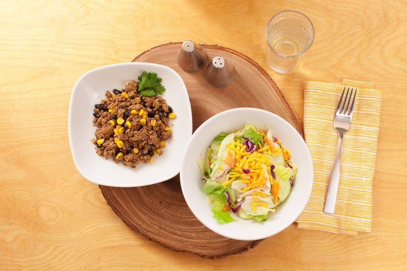 A salad bowl and bean bowl on a round place mat Eat Smart Richmond VA meal delivery service