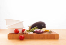 Load image into Gallery viewer, Eggplant tomato onion and other vegetables on a cutting board Eat Smart RVA meal delivery service
