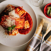 Load image into Gallery viewer, Manicotti with filling topped with tomato sauce and parmesan Eat Smart RVA meal delivery service
