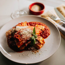 Load image into Gallery viewer, Manicotti with filling topped with tomato sauce and parmesan Eat Smart RVA meal delivery service
