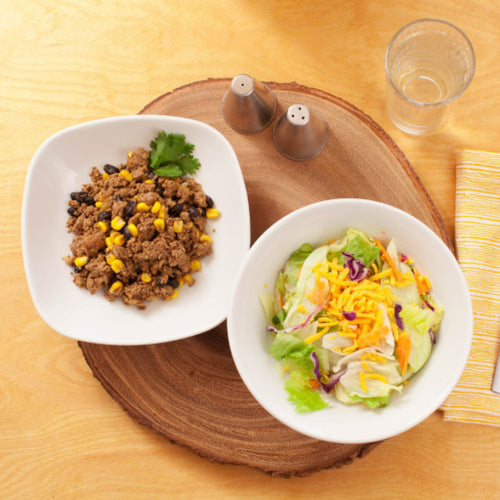 A bowl with turkey with taco seasoning and a bowl with salad Eat Smart RVA meal delivery service