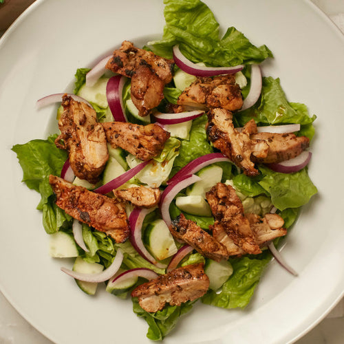 Greens with chicken and red onion in a bowl Eat Smart Richmond VA meal delivery service
